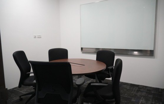 Small discussion room with a round table and whiteboard